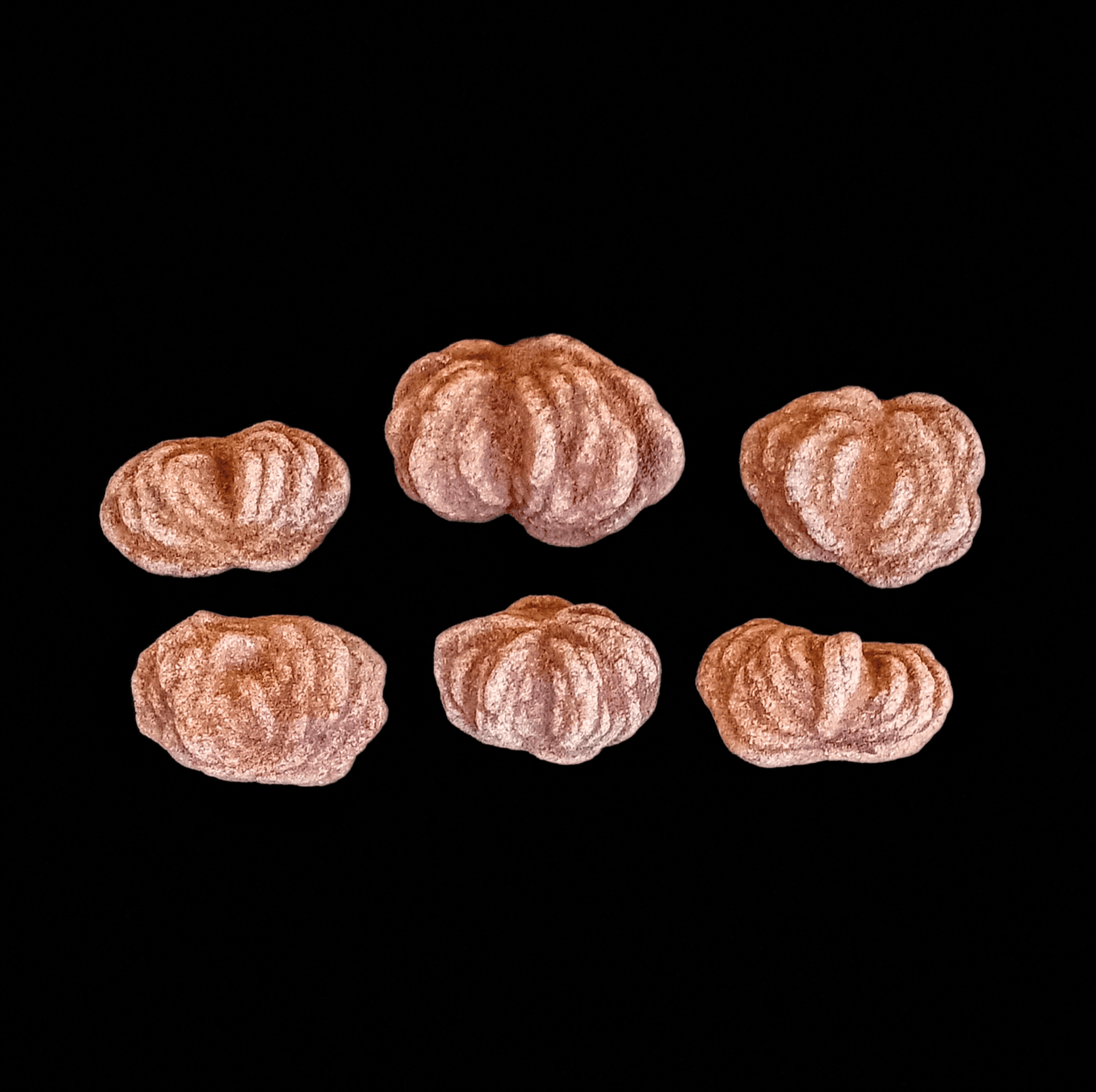 Six barite rose rocks on a black background.